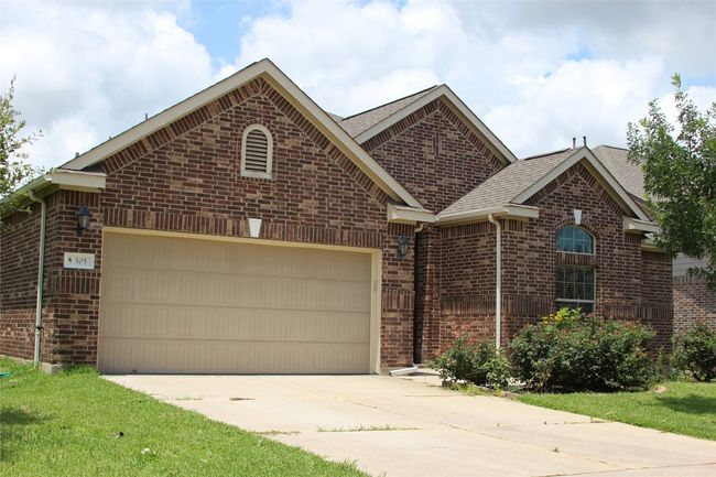 Single story home with brick siding, an attached garage, concrete driveway, and roof with shingles | Image 17