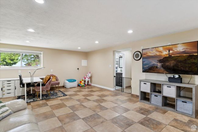 Family room featuring recessed lighting, natural light, tile floors, and a desk | Image 26