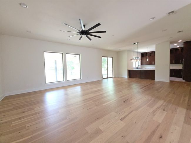 Unfurnished living room featuring light wood finished floors, a sink, recessed lighting, and baseboards | Image 10