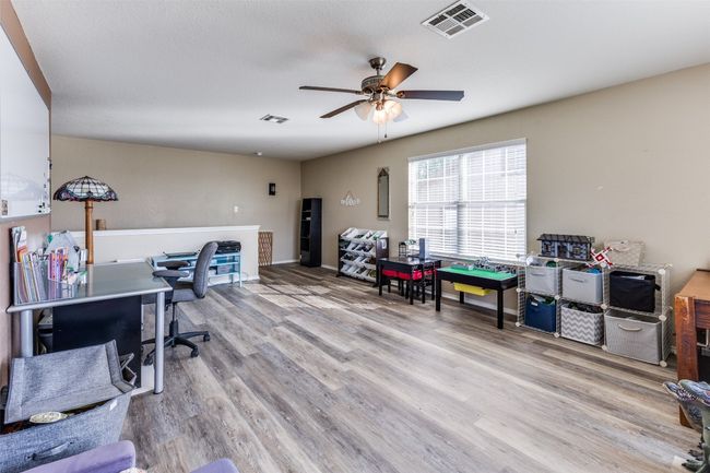 Office space with ceiling fan and wood finished floors | Image 17