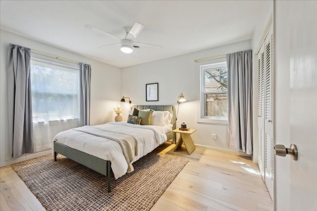 Bedroom featuring light wood-style flooring, baseboards, a closet, and ceiling fan | Image 14
