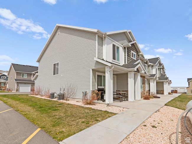 View of home's exterior with a lawn, cooling unit, and a residential view | Image 7