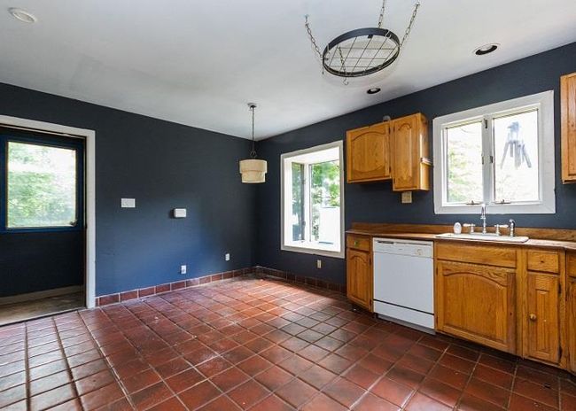 Kitchen with a healthy amount of sunlight, dishwasher, decorative light fixtures, and sink | Image 4