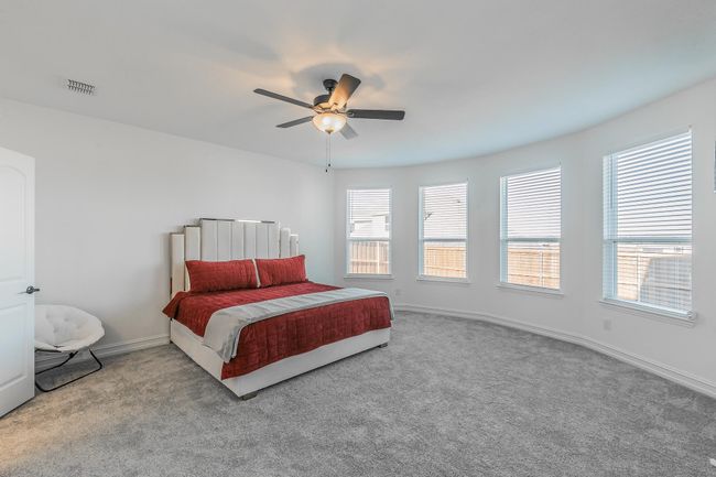 Bedroom with light colored carpet and ceiling fan | Image 24