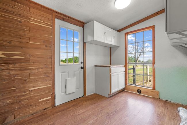 Entryway featuring lofted ceiling, wood finished floors, and a textured ceiling | Image 27