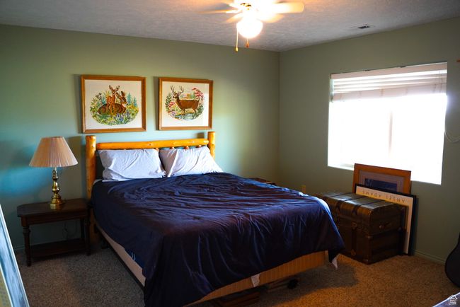 Bedroom featuring carpet flooring and a textured ceiling | Image 24