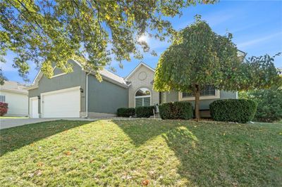 View of front of home with a garage and a front lawn | Image 2