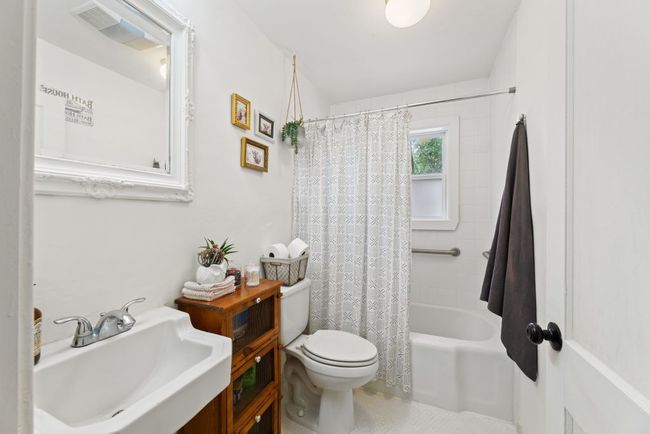 Bathroom with a sink, toilet, and shower / bath combo | Image 8