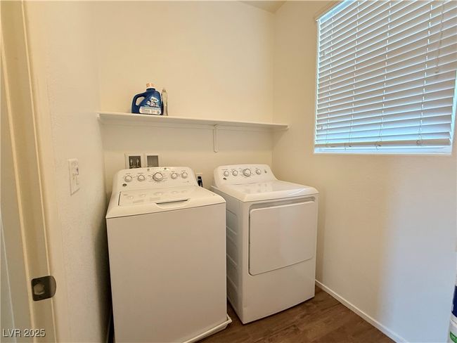 Washroom with washing machine and clothes dryer, laundry area, baseboards, and wood finished floors | Image 10