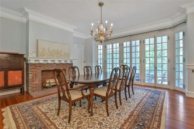 Banquet apportioned, flanked with a wall of french doors and accented with a fireplace | Image 8