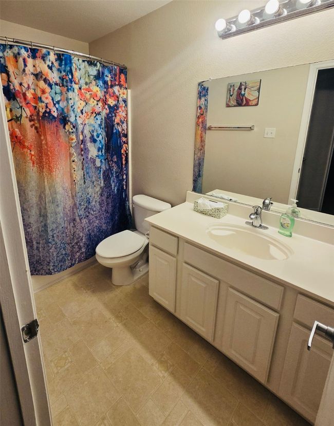 Full bathroom featuring vanity and curtained shower | Image 20