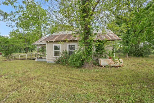 Back of property with fence, metal roof, and a lawn | Image 12