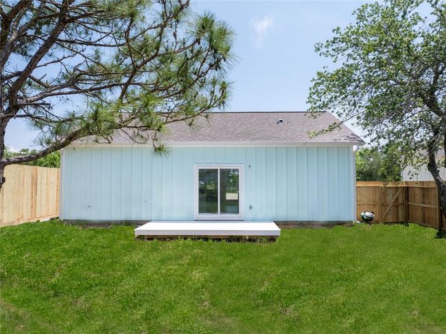 Expansive backyard with a serene view, perfect for relaxation and outdoor activities. | Image 23