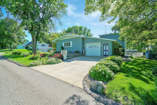 Beautiful landscaping with wonderful cemented driveway. | Image 44