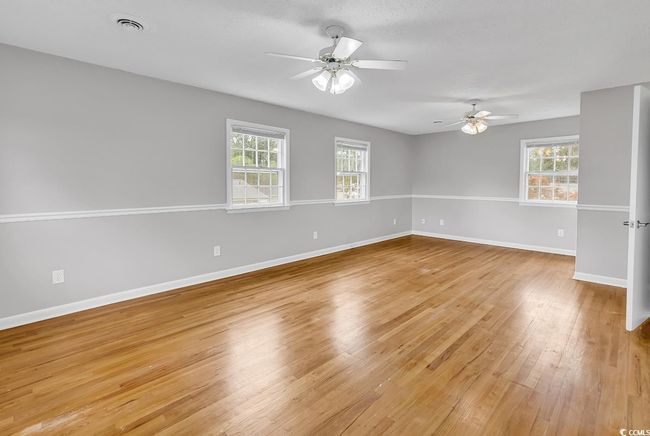 Unfurnished room featuring ceiling fan, light wood-style floors, and healthy amount of natural light | Image 21