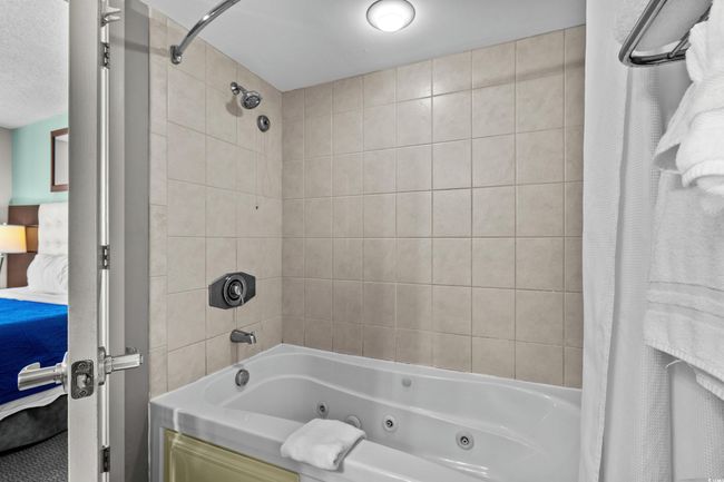 Bathroom featuring a combined bath / shower with jetted tub | Image 21