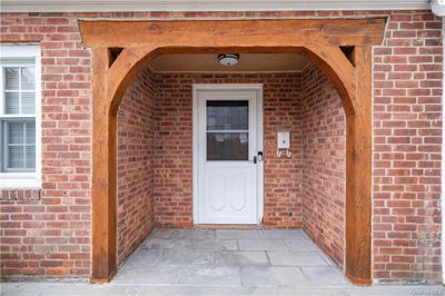 Right facing front view of property showing large screened in sunroom/front porch | Image 2