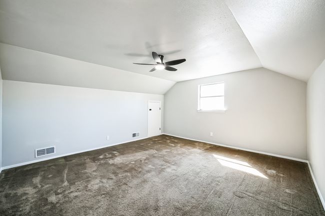 Bonus room with lofted ceiling, baseboards, and visible vents | Image 19