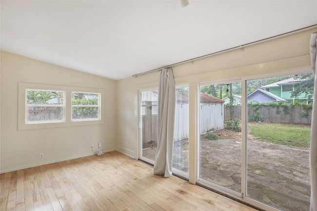 Unfurnished room with hardwood / wood-style floors and vaulted ceiling | Image 24