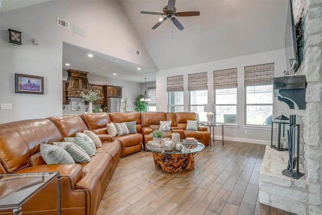 Living room featuring ceiling fan, high vaulted ceiling, light wood finished floors, and recessed lighting | Image 8
