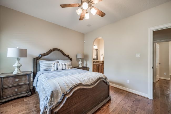 This inviting room features an elegant archway leading to a private vanity area, adding a touch of luxury. | Image 20