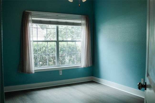 Spare room with healthy amount of natural light and wood finished floors | Image 28