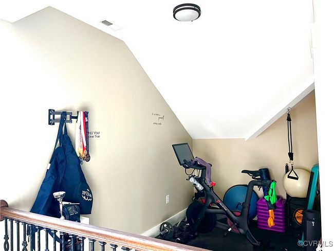 Exercise room with vaulted ceiling and baseboards | Image 34