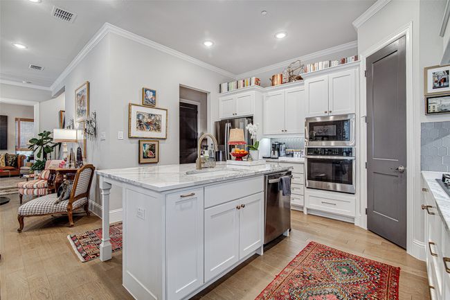 Kitchen featuring appliances with stainless steel finishes, light wood finished floors, a sink, and visible vents | Image 13