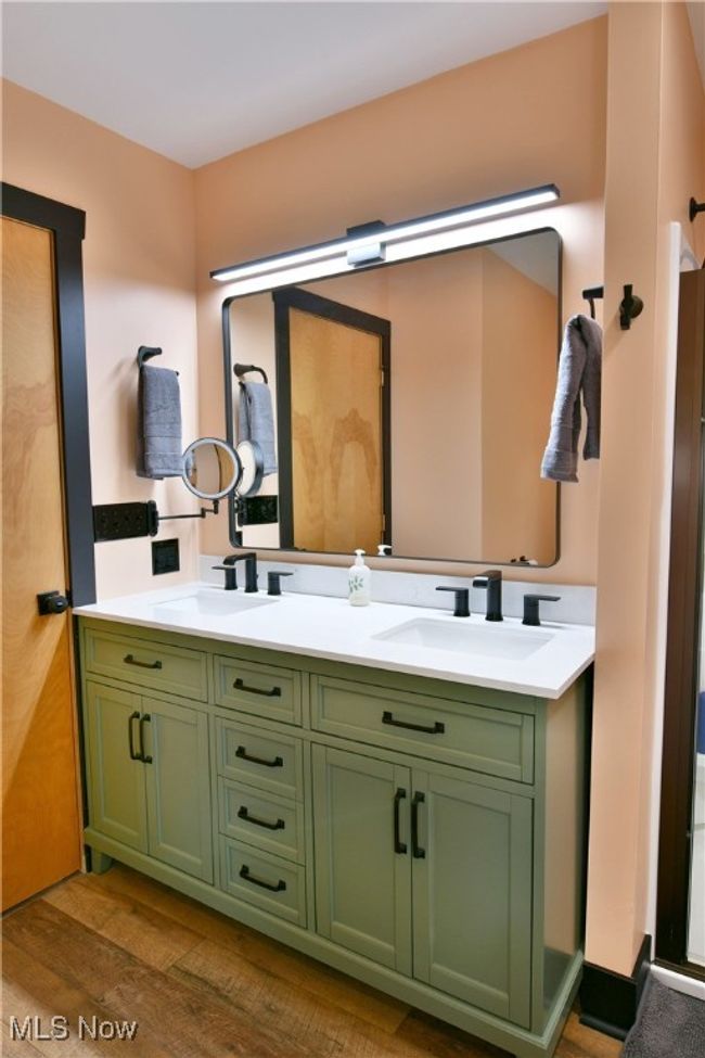 Bathroom featuring double vanity and wood finished floors | Image 33
