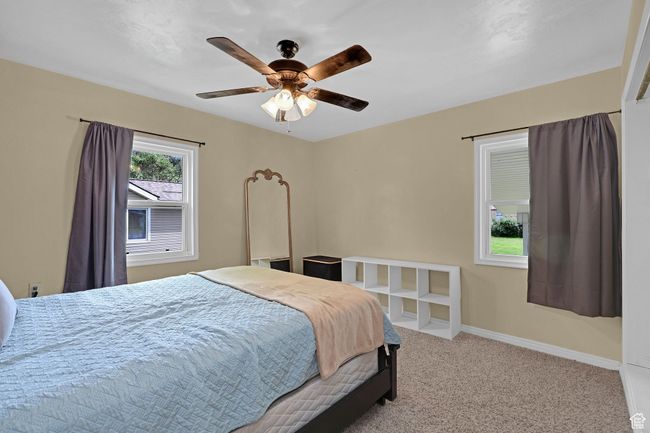 Carpeted bedroom with baseboards and a ceiling fan | Image 17