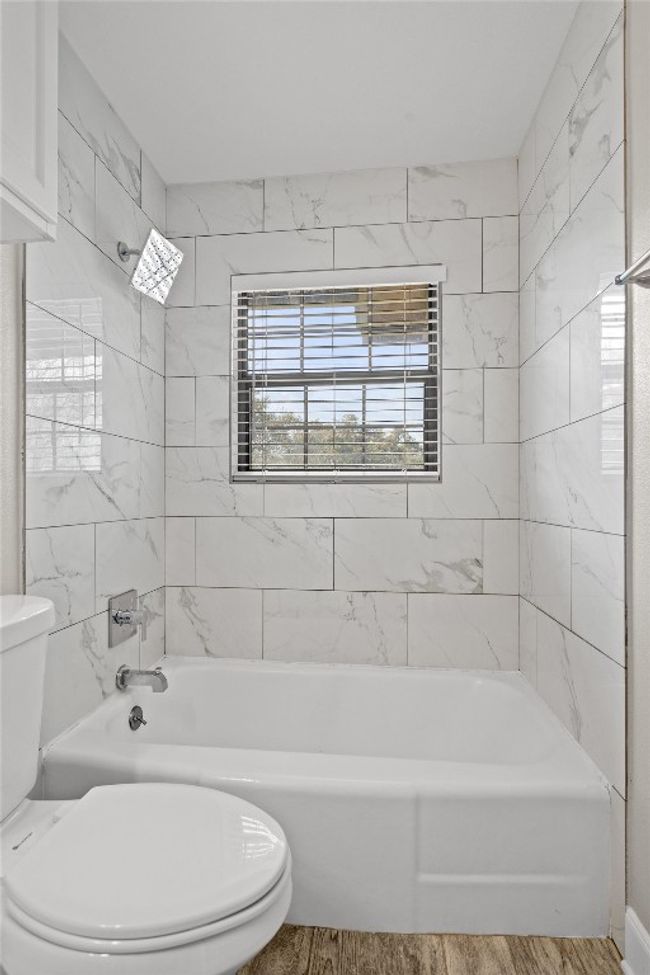 Full bathroom with toilet, wood finished floors, and tub / shower combination | Image 28
