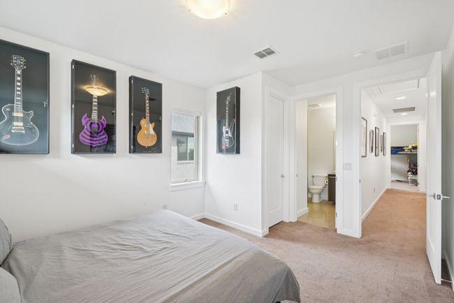 Carpeted bedroom with baseboards and ensuite bath | Image 23