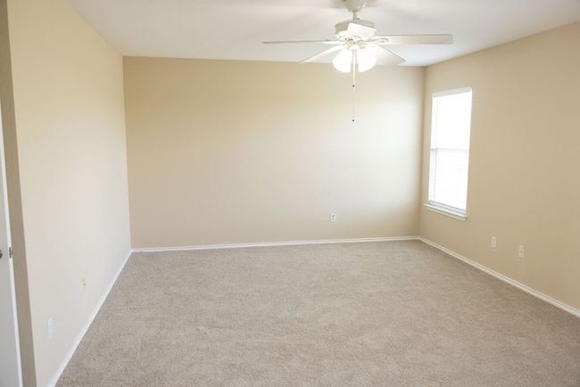 Primary Room featuring new carpeting, ceiling fan, and baseboards | Image 12