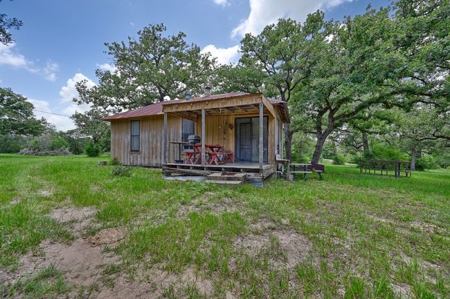 View of front facade featuring a metal roof, an outbuilding, and board and batten siding | Image 17