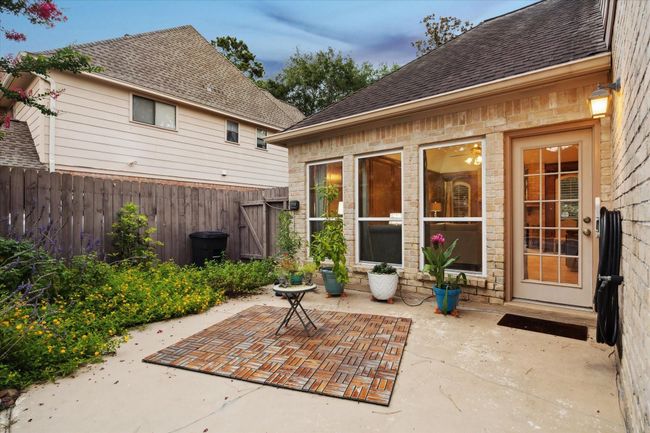 This charming patio area is accessible from the living room and is bordered by the butterfly garden and extends towards the pool. | Image 33