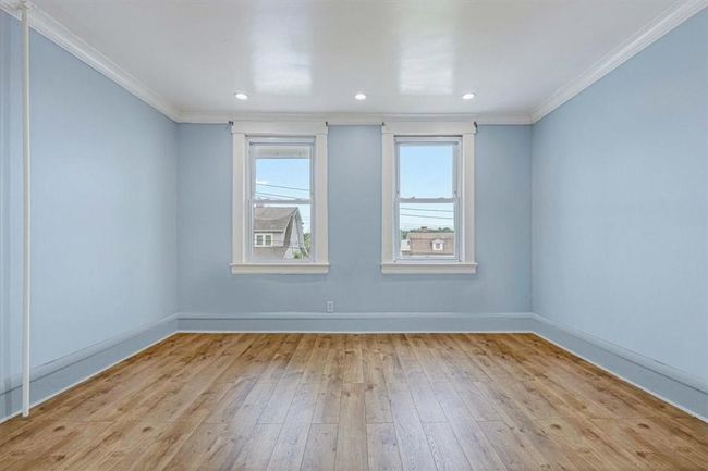 Unfurnished room with light wood-type flooring and ornamental molding | Image 12