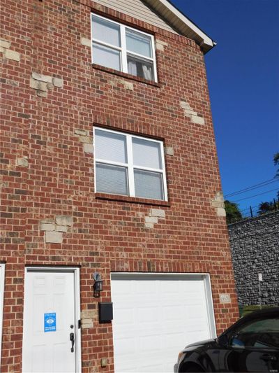 View of home's exterior with a garage | Image 1