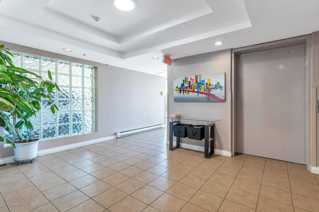 Spare room with light tile patterned floors, baseboard heating, baseboards, and a tray ceiling | Image 32