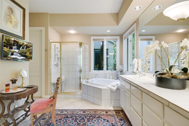 Primary bath featuring a garden tub, walk in shower and double sinks | Image 18