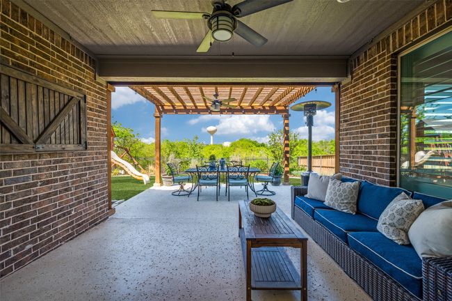 Walk out to this extended covered patio and enjoy the evenings knowing there will be no bugs! Mosquito misters are an added bonus as well as this additional pergola for entertaining. | Image 31