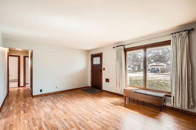 Living room leads to 3 bedrooms and bathroom. Fresh, neutral decor. | Image 7