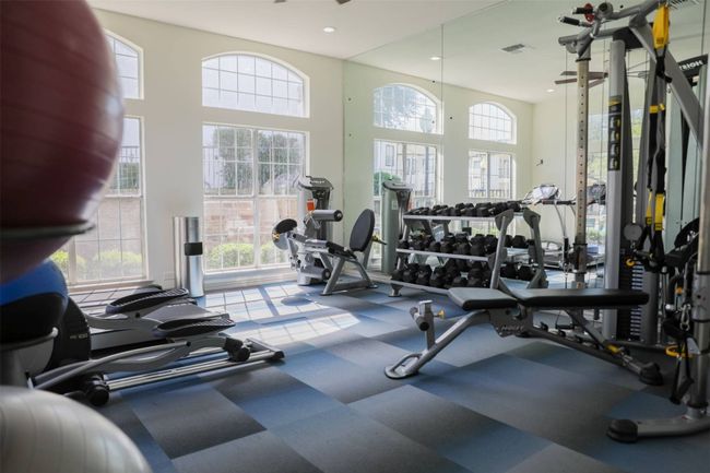 Workout area featuring a wealth of natural light and a high ceiling | Image 12