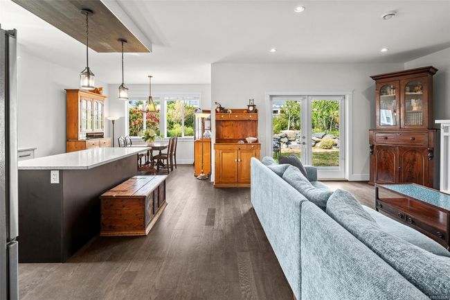 Living area with dark wood-style floors, french doors, and recessed lighting | Image 9