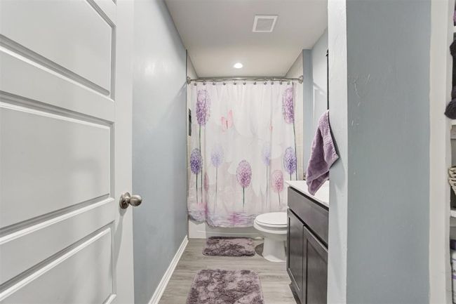 Full bathroom featuring vanity, wood finished floors, a shower with shower curtain, and recessed lighting | Image 33