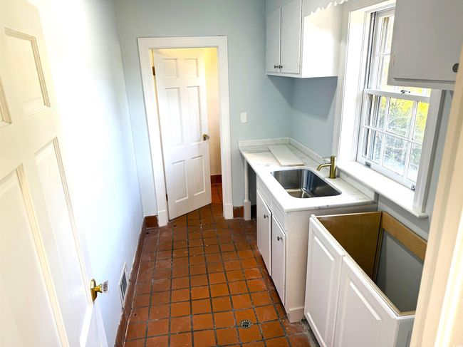 Kitchen featuring white cabinetry and sink | Image 25