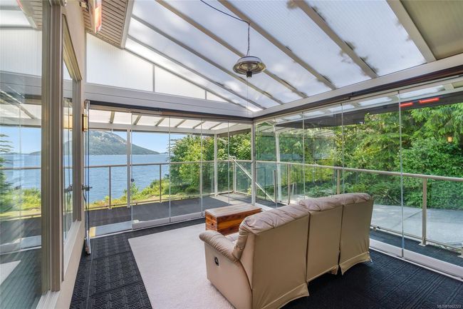 Sunroom / solarium with vaulted ceiling and a water view | Image 86