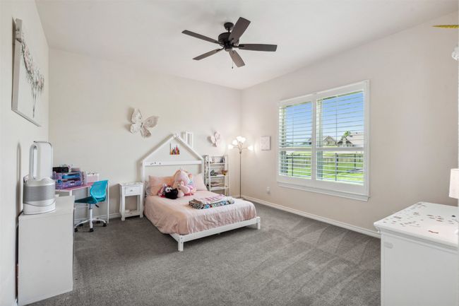 Carpeted bedroom featuring ceiling fan and baseboards | Image 31
