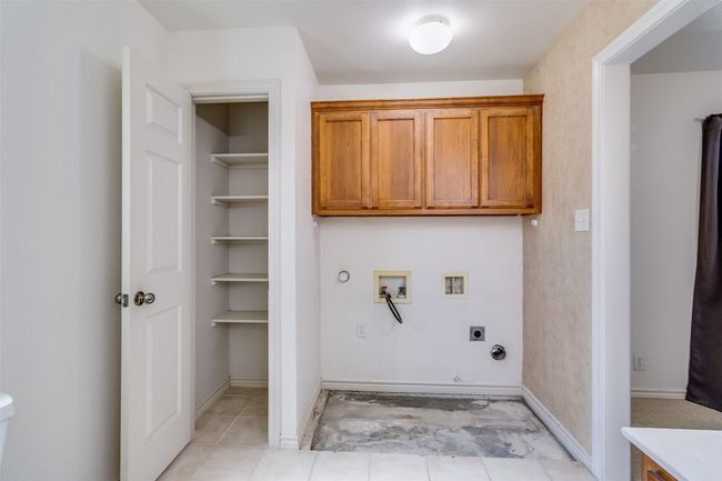Laundry room featuring cabinet space, electric dryer hookup, gas dryer hookup, and washer hookup | Image 21