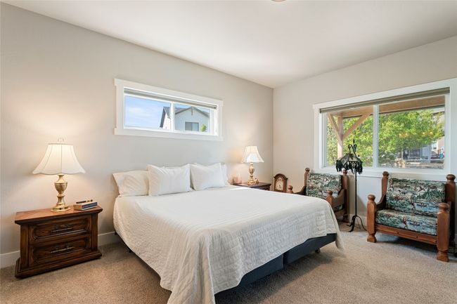 Bedroom featuring light carpet, multiple windows, and baseboards | Image 16