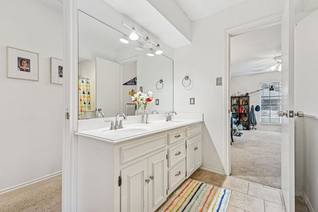 Full bathroom featuring double vanity, ceiling fan, tile patterned floors, and baseboards | Image 19